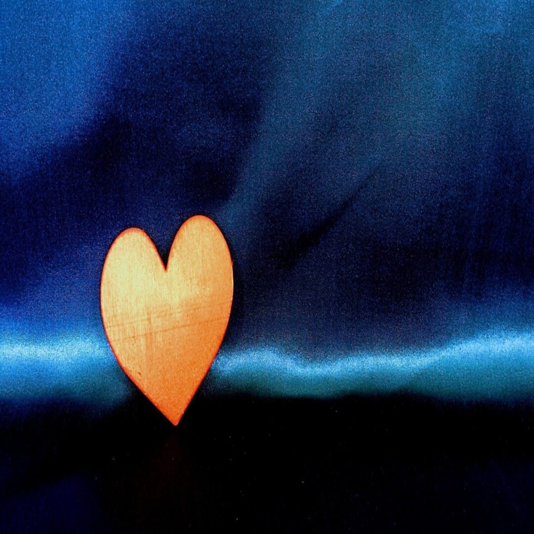 A yellow color heart on a blue background